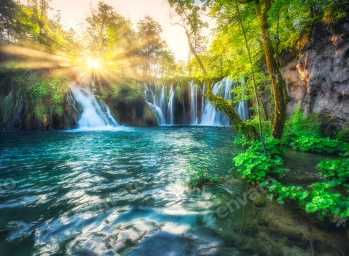 Preview: Waterfall in green forest in Plitvice Lakes, Croatia at sunset
