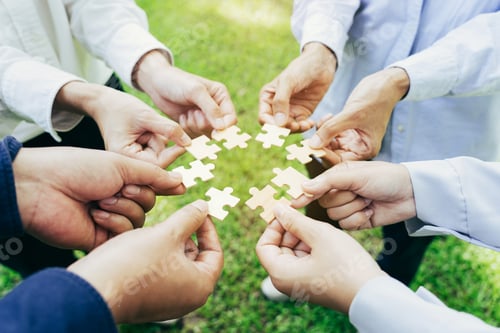Preview: group of business people assembling jigsaw puzzle. The concept of cooperation