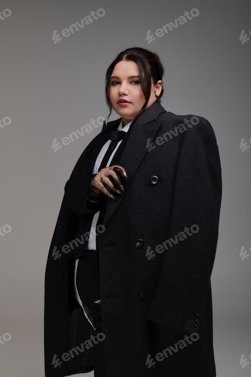 Preview: Stylish and confident plus size woman showcasing modern fashion in a creative setting