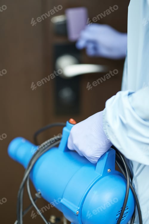 Preview: Worker using a special agent for disinfecting the room