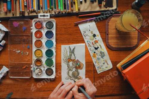 Preview: female artist painter painting a picture of a easter bunny