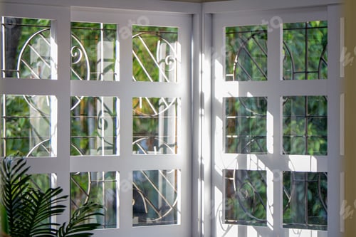 Preview: Stunning view of the outdoors seen through a beautiful window featuring intricate glass designs