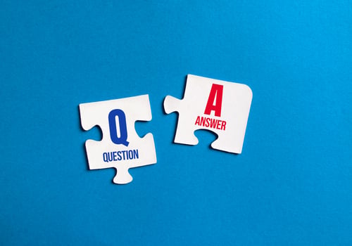 Puzzle Pieces Representing Question and Answer on Blue