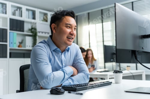 Preview: Asian handsome business man using laptop computer working in office.
