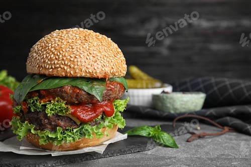 Preview: Delicious burger with meat cutlets on grey table. Space for text