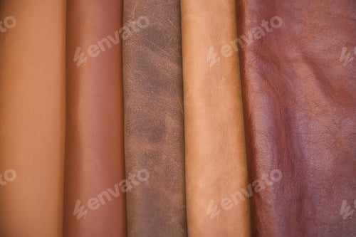 Preview: Array of leather fabric samples in different shades neatly placed on a table, ready to be crafted