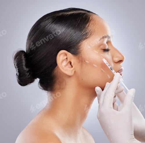 Preview: Shot of an attractive young woman getting filler injections in the studio