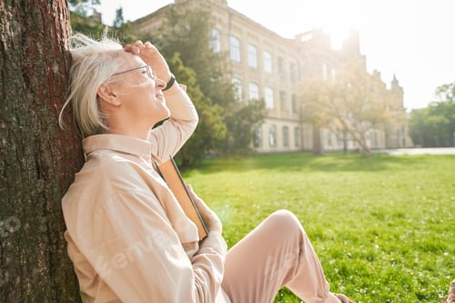 Preview: Cheerful blonde female enjoying nature in the park
