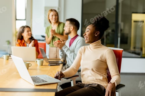 Preview: Young multiethnic startup team working in the modern office