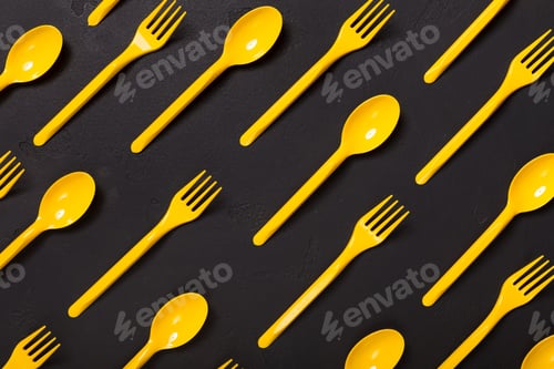 Preview: Top view on plastic forks on black background