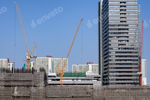 Preview: Construction site building with yellow crane and scaffolding