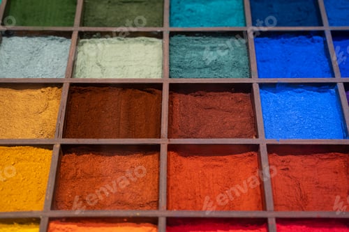 Preview: Colorful pigments arranged in wooden grid