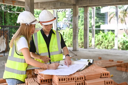 Preview: Professional engineering team working at construction site together.