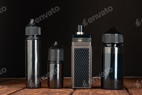 Preview: Vape and vape liquid bottles against black background