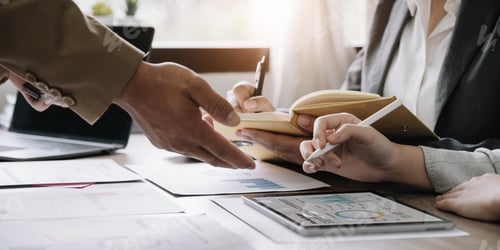 Preview: Business People Meeting using laptop computer,calculator,notebook,stock market chart paper for