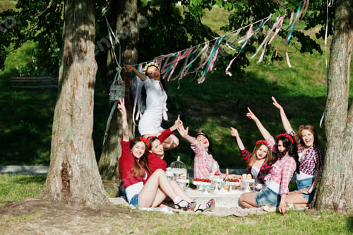 Preview: Happy and sexy girls sitting at picnic table and having fun on bachelorette party