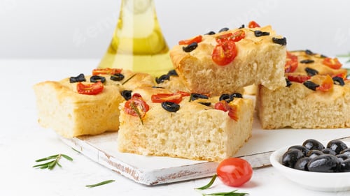 Preview: Focaccia with tomatoes, olives and rosemary, side view. Traditional Italian flat bread