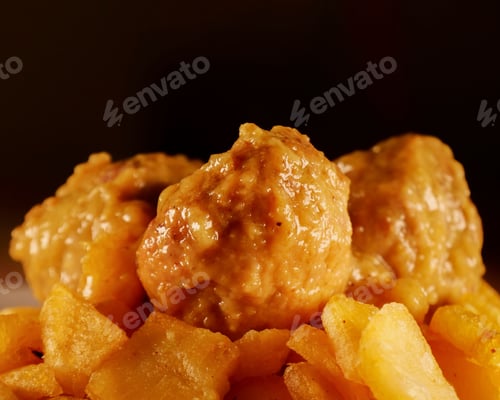 Preview: Closeup of appetizing vegan wings against a black background