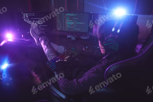 Preview: Computer Programmer Working in Dark