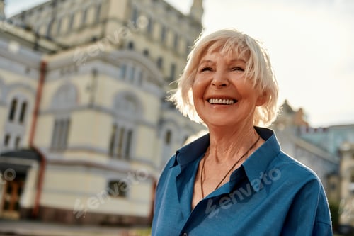 Preview: Good mood! Portrait of beautiful and happy senior woman smiling while standing outdoors on a sunny