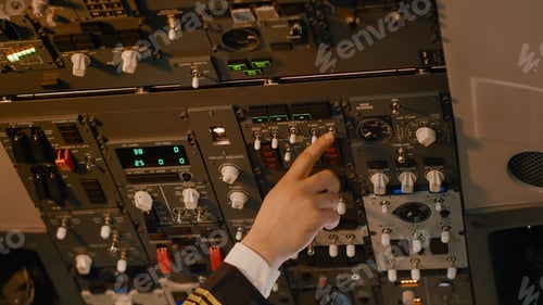 Preview: Male captain pushing dashboard buttons to start airplane engine