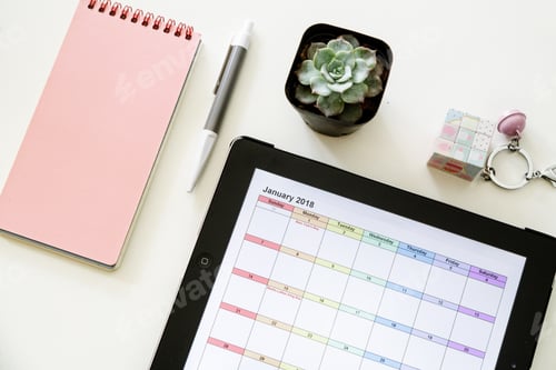 Preview: Desktop flat lay with opened calendar on tablet and office supplies on white background
