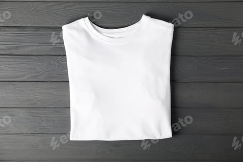 Preview: White t-shirt on grey wooden table, top view. Mockup for design