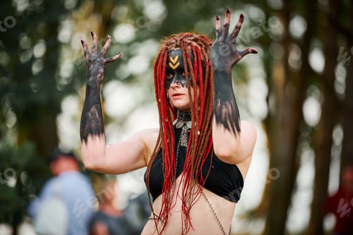 Preview: Mythological dancing girl faun on green lawn in public park outdoor art dancing event