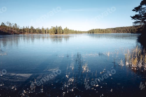 Preview: Frozen Nordic Lake Under Blue Sky