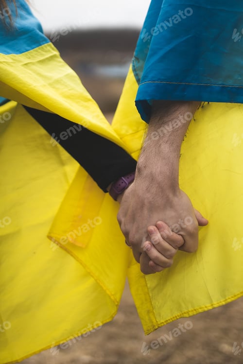 Preview: Couple in love holding the flag of Ukraine. Flag of Ukraine. The war in Ukraine. Patriots. Freedom.