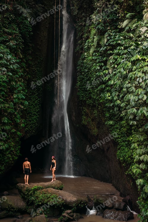 Preview: Couple at a tropical waterfall. The couple travels to the island of Bali in Indonesia