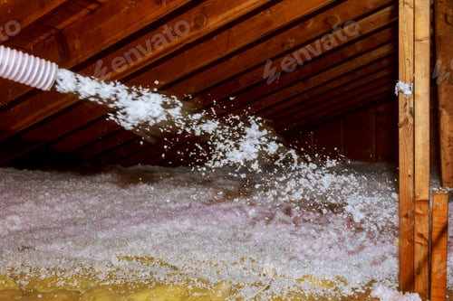 Preview: Worker Spraying mineral rock wool of thermal insulation layer under the roof house attic insulation