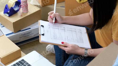 Preview: Woman checks stock files for shipping to customers, Online sales, Parcel delivery.