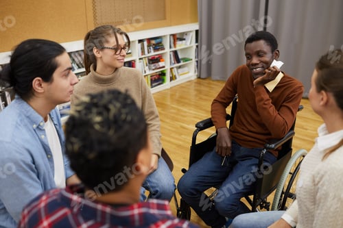 Preview: Smiling Man in Wheelchair Sharing with Support Group