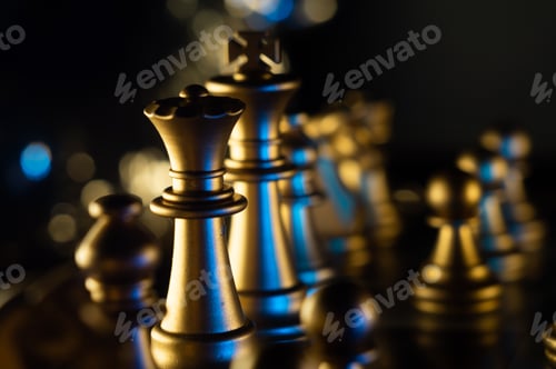 Preview: Selective-focus shot of the king and the queen chess pieces on the board with bokeh lights