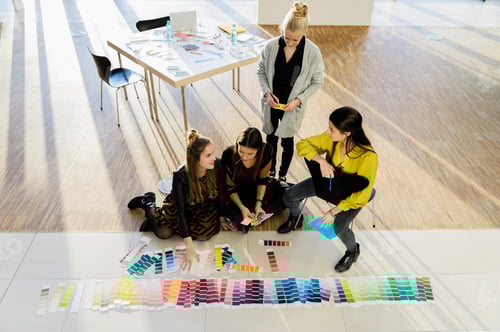 Preview: Colleagues sitting on floor working with colour swatches