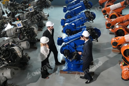 Preview: Businessman and businesswoman talking in a factory