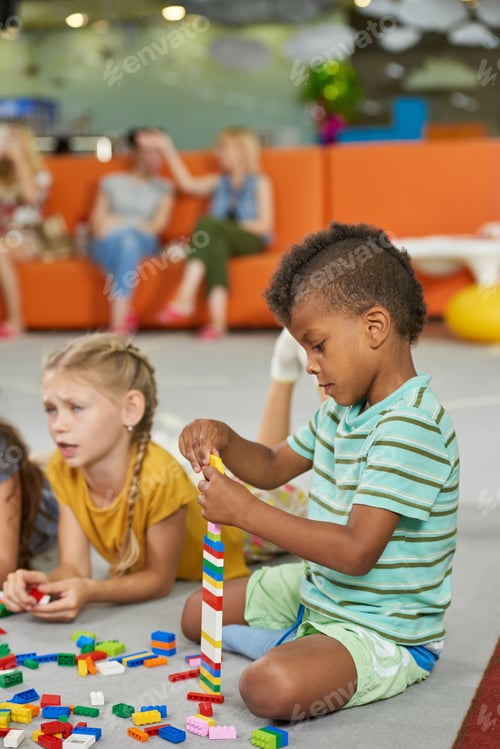 Preview: Children Building Tower with Colorful Blocks Indoors
