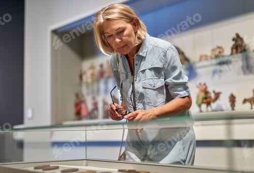 Preview: Mature Woman Looking At Exhibit
