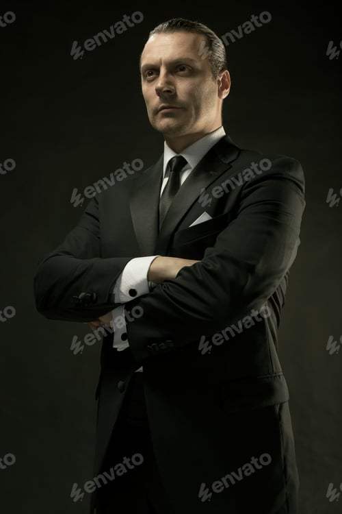 Preview: The Attractive Man In Black Suit On Dark Background