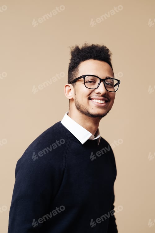 Preview: Afro Good looking guy in black sweater and glasses posing on beige background