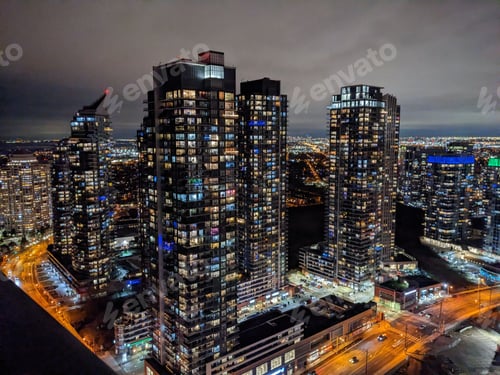 Preview: View of a vibrant city skyline at night, illuminated by bright lights