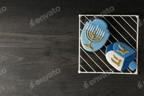 Preview: Gingerbread cookies with Jewish symbols on wooden background, space for text