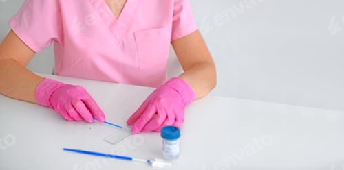 Preview: Laboratory technician in pink gloves preparing medical test sample on white table.