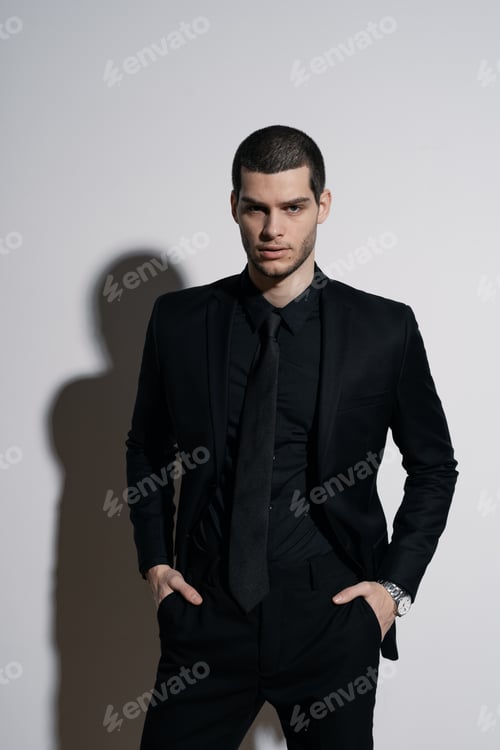 Preview: Young handsome businessman in black shirt and black suit