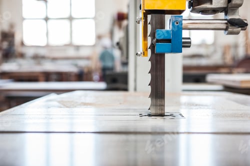 Preview: Close up view of a band saw in a woodworking factory.