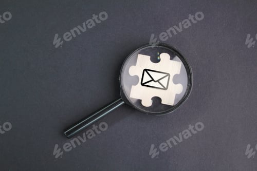 Preview: magnifying glass and wooden puzzle with email icon