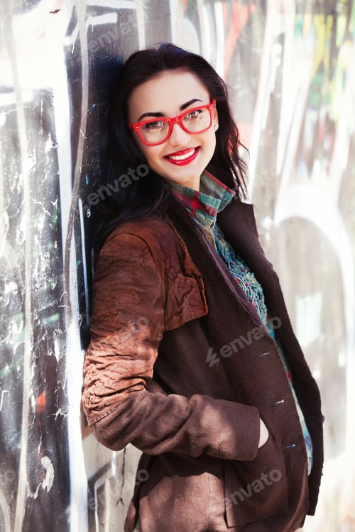 Preview: Teen girl near graffiti wall.
