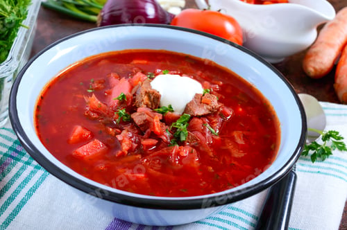 Preview: Borsch is a traditional Ukrainian dish in a bowl and products for its preparation.