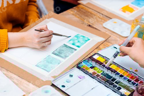 Preview: Watercolor Painting Workshop. Close-up of hands painting with brushes.